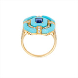 Bold 14K yellow gold cocktail ring featuring 9ct of hand-carved turquoise, a 0.75ct elongated emerald-cut sapphire, and 0.6ct of G-H VS diamonds in a striking Art Deco design.