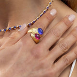 Chic 14K yellow gold ribbed bypass ring featuring a bold pairing of purple amethyst and hot pink tourmaline, with sculptural proportions—27.5mm height, 22mm length, and total weight of 12.90g.