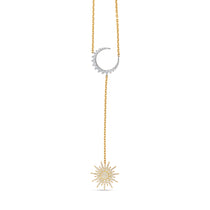 Elegant celestial drop necklace crafted in 14K two-tone gold, featuring radiant diamonds that shimmer with every angle, blending modern style with timeless sophistication. Close up of moon and sun.