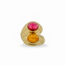 Striking 14K yellow gold bypass ring featuring vibrant orange spessartite and pink tourmaline cabochons, set in a fluted band for a bold and opulent statement. Front close up.