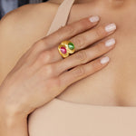 Bold 14K yellow gold bypass ring featuring vibrant 2.75ct pink and green cabochon-cut tourmalines, set in a ribbed design with sculptural elevation—measuring 27.5mm high and weighing 12.05g.