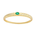 Refined 14K yellow gold bangle featuring a centered emerald flanked by sparkling diamonds, combining classic elegance with vibrant color for a timeless bracelet design.