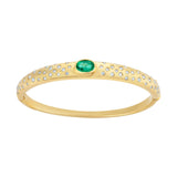 Refined 14K yellow gold bangle featuring a centered emerald flanked by sparkling diamonds, combining classic elegance with vibrant color for a timeless bracelet design.