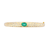 Refined 14K yellow gold bangle featuring a centered emerald flanked by sparkling diamonds, combining classic elegance with vibrant color for a timeless bracelet design.
