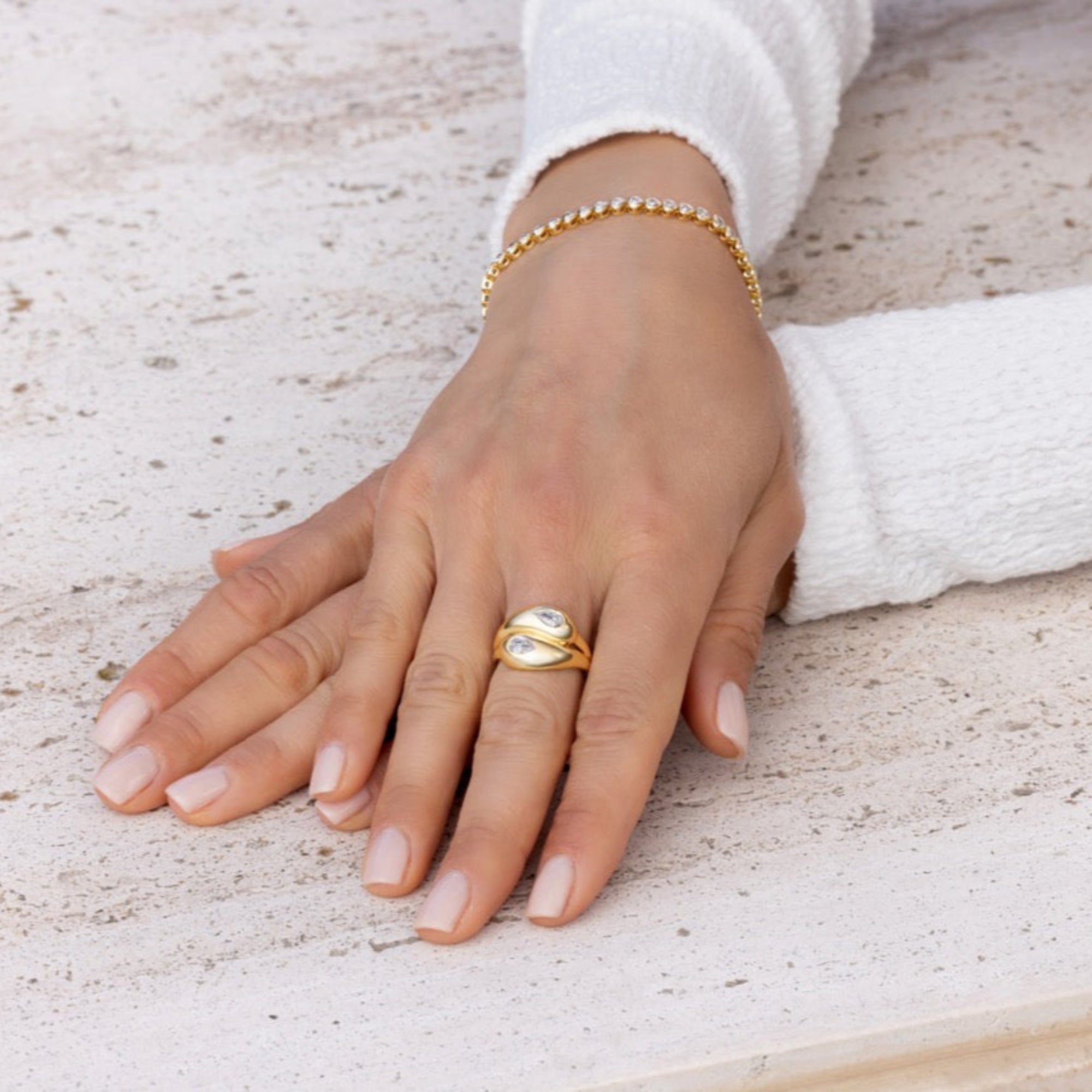 Elegant 14K yellow gold knot ring featuring two pear-shaped diamonds totaling 0.623ct (G-H VS), with a graceful, sculptural silhouette measuring 5.9mm by 4.2mm and weighing 5.2g.
