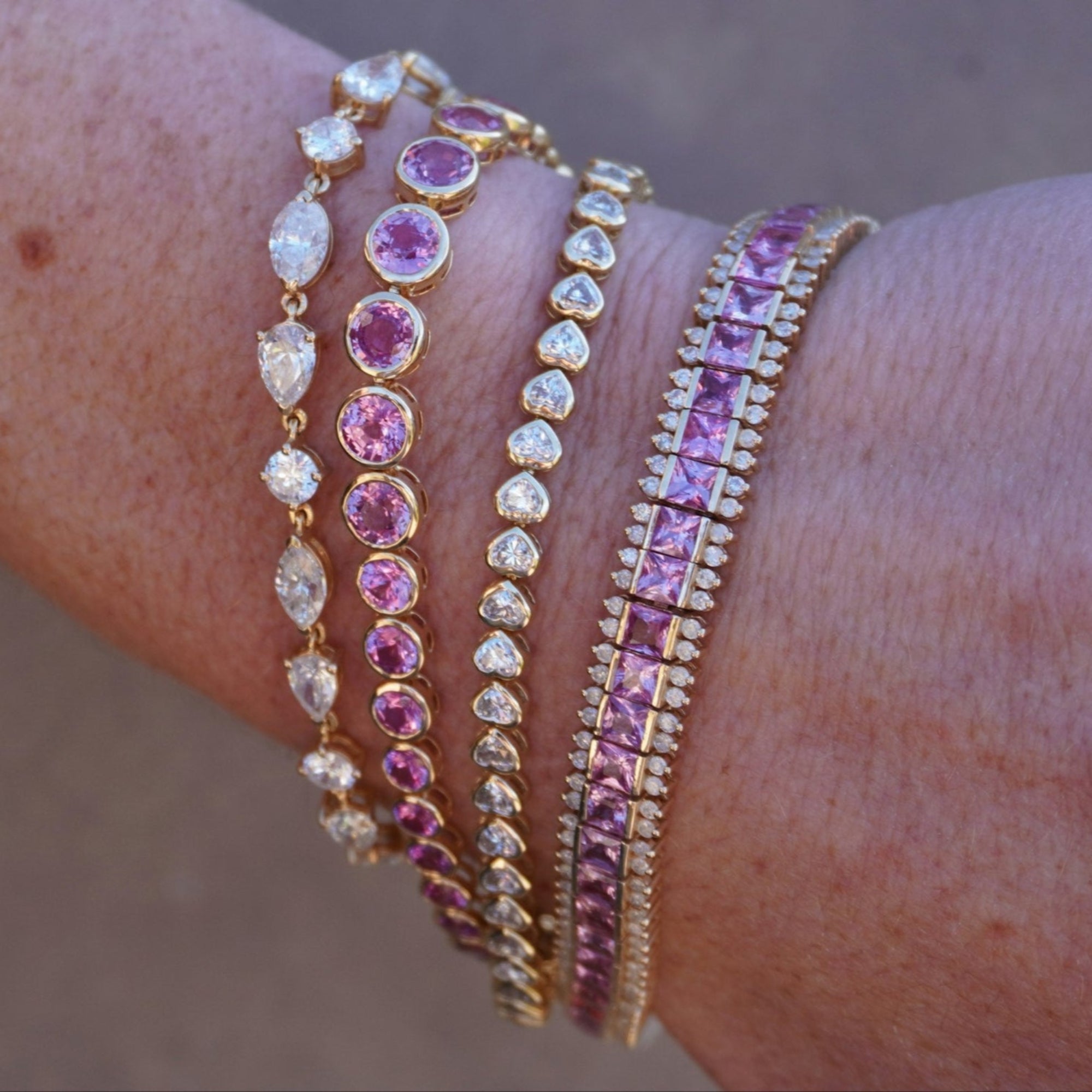 Stunning 14K yellow gold tennis bracelets featuring pink sapphires and  diamonds. 