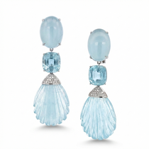 These Hand-Carved Aquamarine and Diamond Drop Earrings are a sculptural ode to light, water, and craftsmanship. Carved from over 110 carats of luminous aquamarine, each gemstone flows with organic elegance, suspended in a cool-toned setting of 18K white gold. Accented by pavé-set diamonds, the composition captures movement and serenity in equal measure.