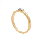 Stackable 14K yellow gold ring featuring a 0.29ct emerald cut diamond solitaire, with a sleek, minimalist profile measuring 3.1mm by 3.6mm and a total weight of 2.42g.
