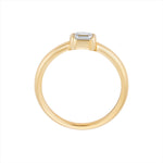 Stackable 14K yellow gold ring featuring a 0.29ct emerald cut diamond solitaire, with a sleek, minimalist profile measuring 3.1mm by 3.6mm and a total weight of 2.42g.
