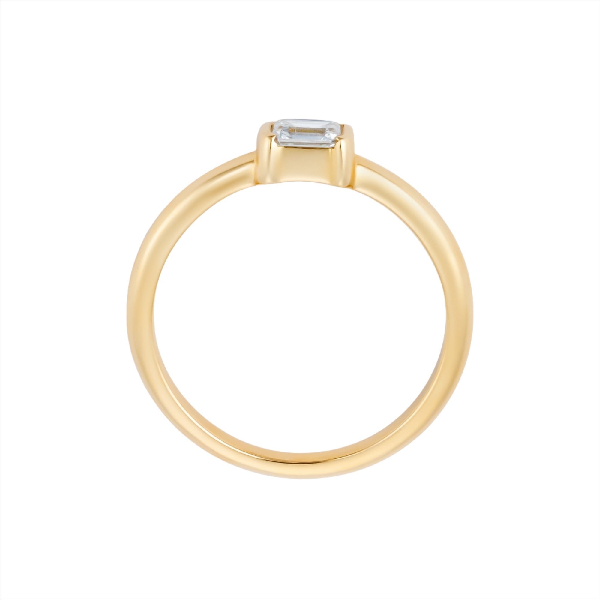 Stackable 14K yellow gold ring featuring a 0.29ct emerald cut diamond solitaire, with a sleek, minimalist profile measuring 3.1mm by 3.6mm and a total weight of 2.42g.
