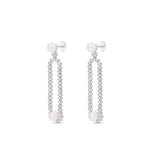 Gracefully designed drop earrings in 18K white gold, featuring dazzling diamonds and luminous pearls, offering refined craftsmanship and timeless allure for special occasions. Side view.