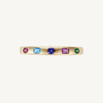 Side view of the original five-stone multicolor bangle in 14K yellow gold, showing the flush-set mixed-shape stones along the 21.71g cuff.
