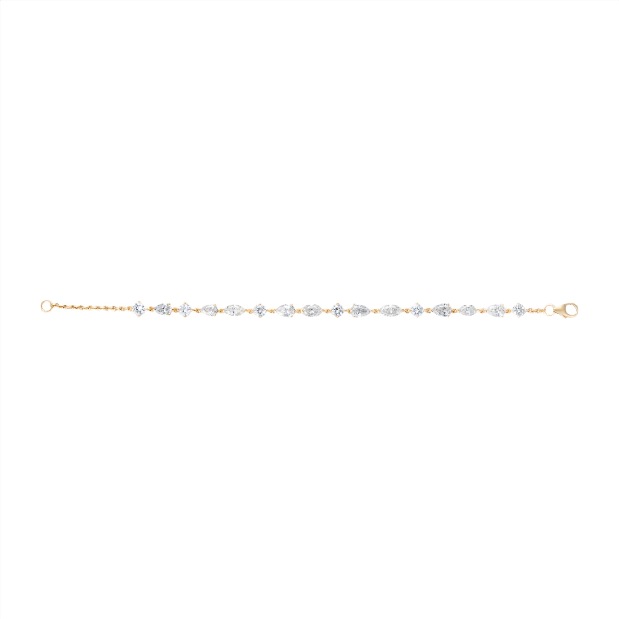 Beautiful 14K yellow gold line bracelet featuring 5.75ct of mixed shape diamonds (G-H color, VS clarity), measuring 6.5 inches in length with a widest stone size of 4.6mm.