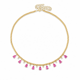 A gold chain necklace with a delicate beaded collar design and dangling pink teardrop-shaped gemstones, shown on a plain white background.