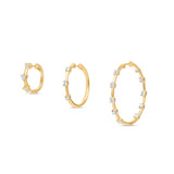 Trio of Elyzian Diamond Prong Set Huggie Hoop Earrings in 14K Yellow Gold shown side by side in graduated sizes