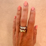 Dual-tone cigar band on a white background; both yellow and white gold have scattered natural diamonds.