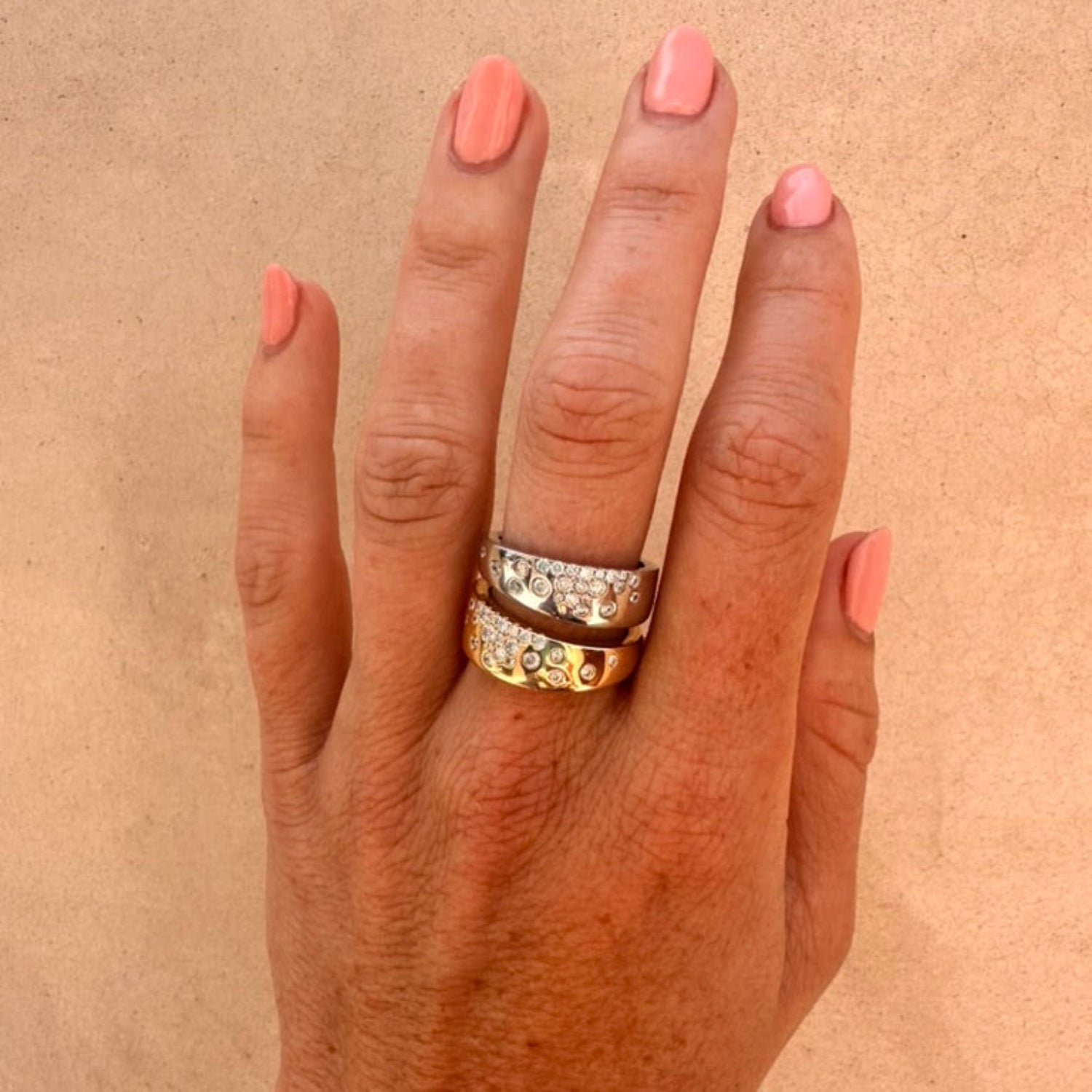 Dual-tone cigar band on a white background; both yellow and white gold have scattered natural diamonds.