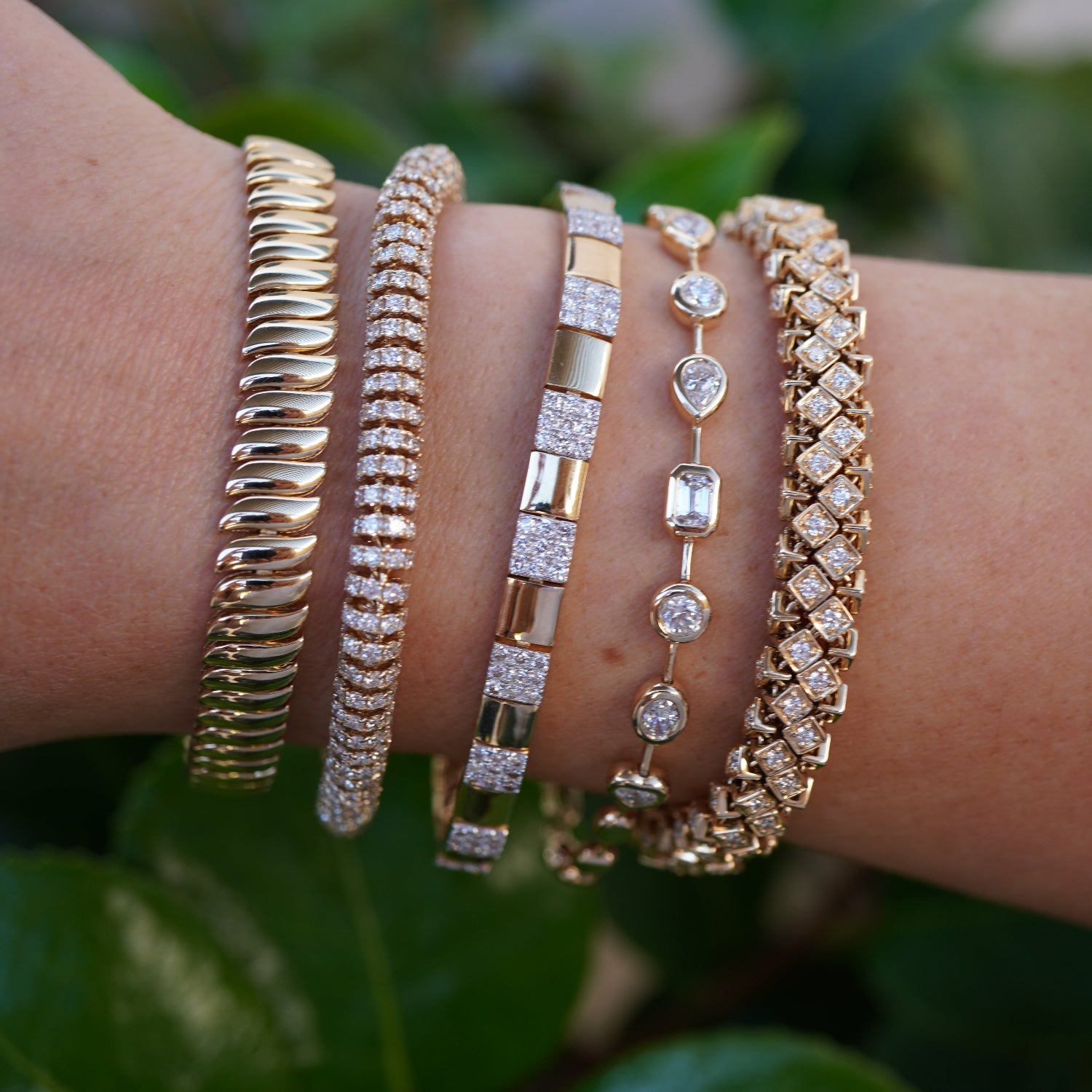Luxurious 14K yellow gold rope bracelet featuring an intricate woven design accented with dazzling diamonds, blending timeless sophistication with modern brilliance for a stunning statement piece. Close up on arm.