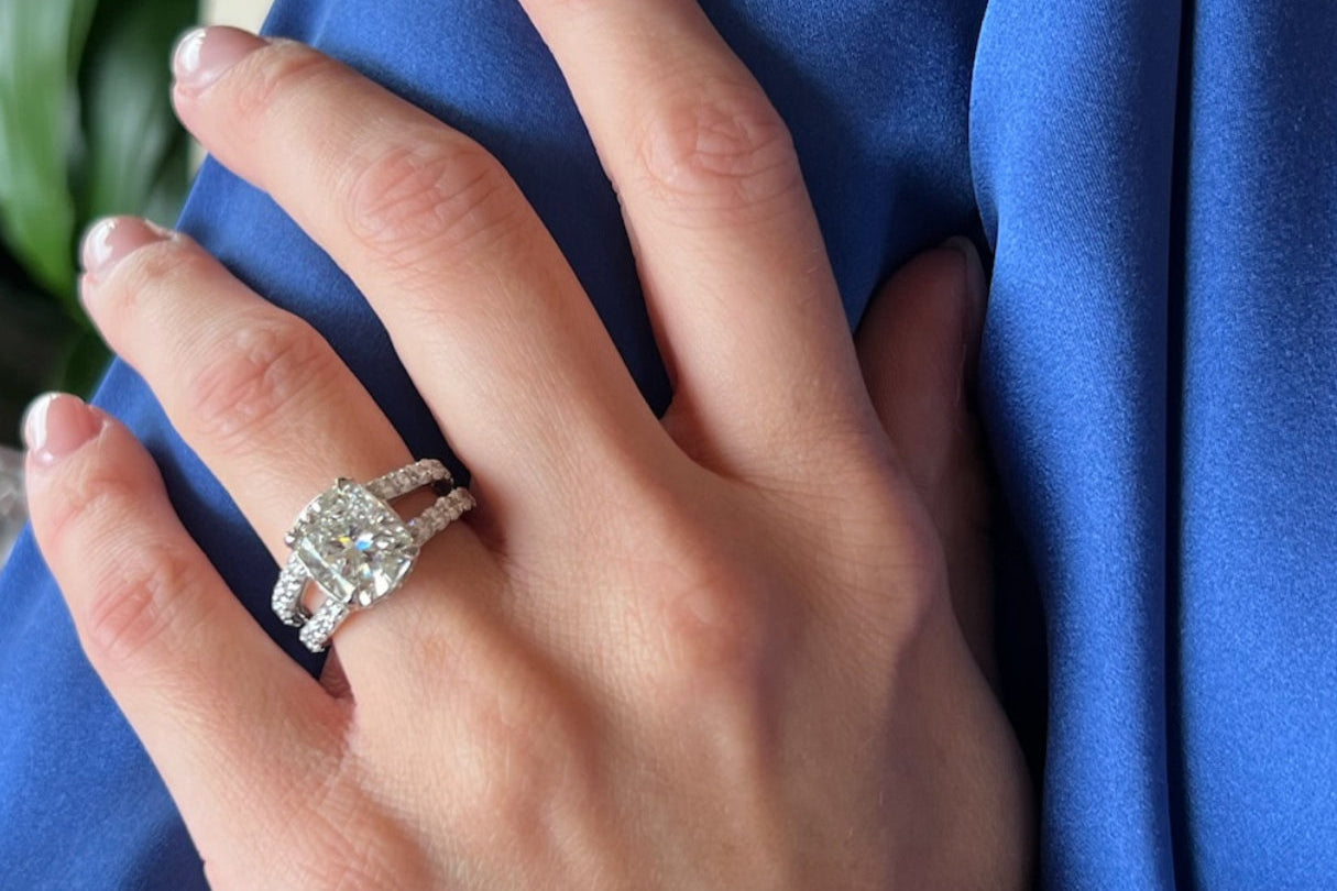 Custom cushion-cut diamond engagement ring with sparkling halo, showcasing Elyzian's bespoke design