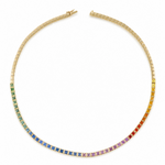 A gold tennis necklace featuring a gradient of square-cut gemstones transitioning from green and blue on the left, through purple, pink, and orange, to yellow on the right, displayed on a solid white background.