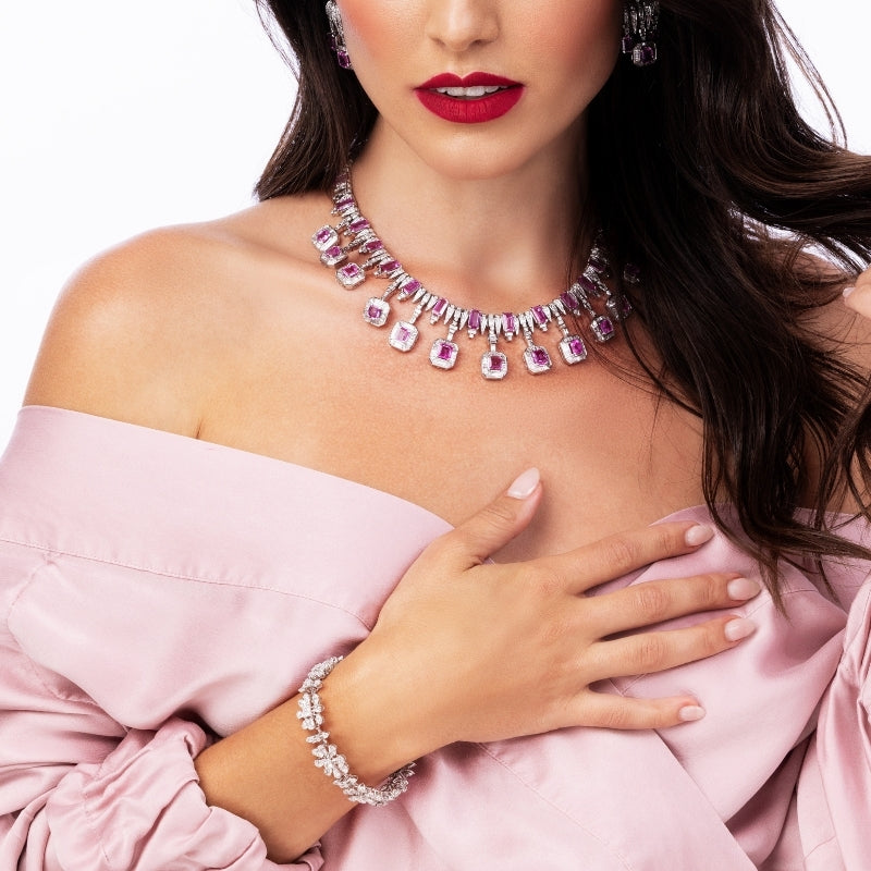 Model wearing Elyzian one-of-a-kind pink sapphire and diamond statement necklace with matching
earrings and diamond bracelet