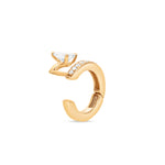 Gold ear cuff with a pear shape diamond accent on a white background