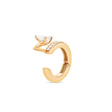 Gold ear cuff with a pear shape diamond accent on a white background