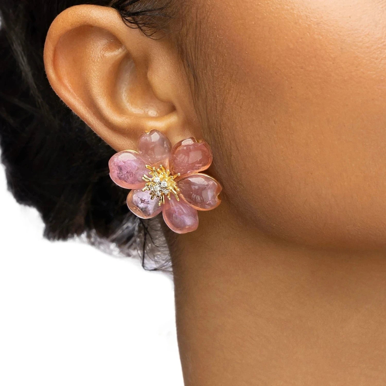 Exquisite one-of-a-kind 18K yellow gold clip-on stud earrings featuring meticulously hand-carved pink tourmaline plum blossoms, accented with sparkling diamonds for a refined and elegant floral statement. Close up front angle. 