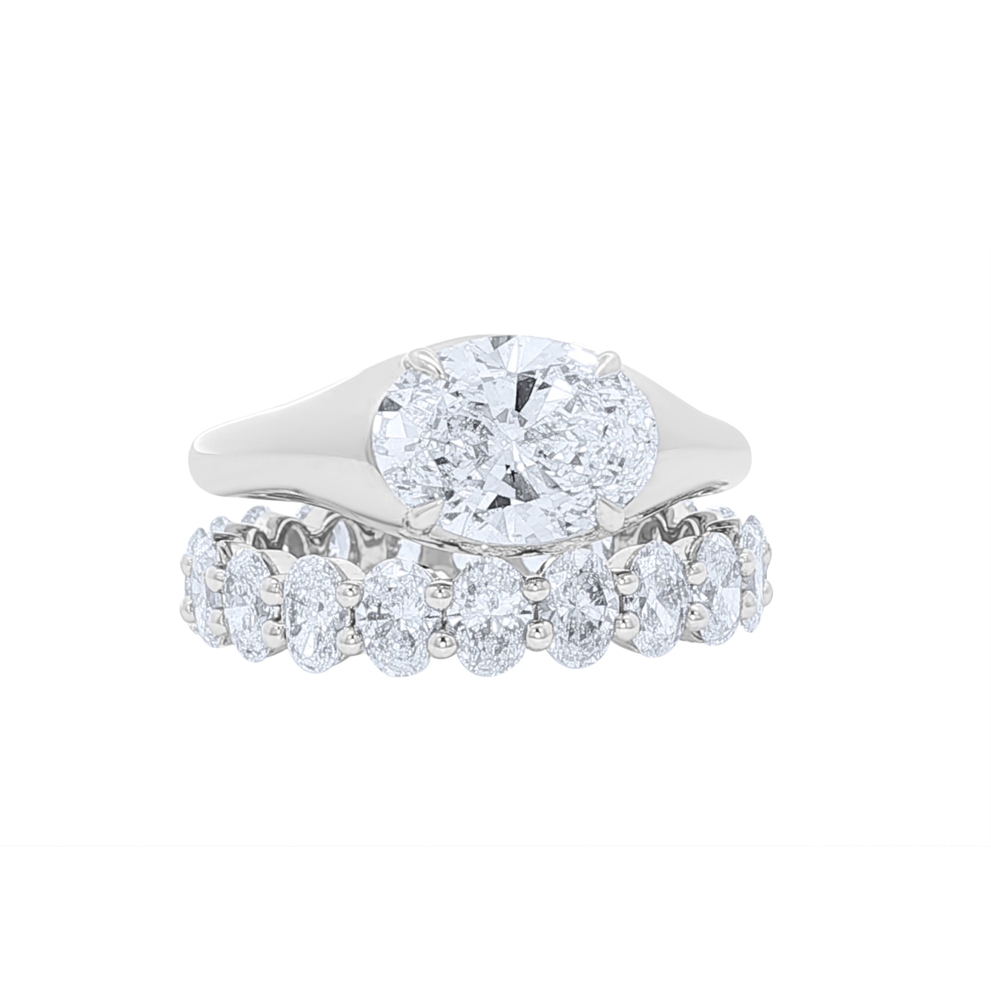 Lab grown oval diamond eternity band and oval east west engagement ring 