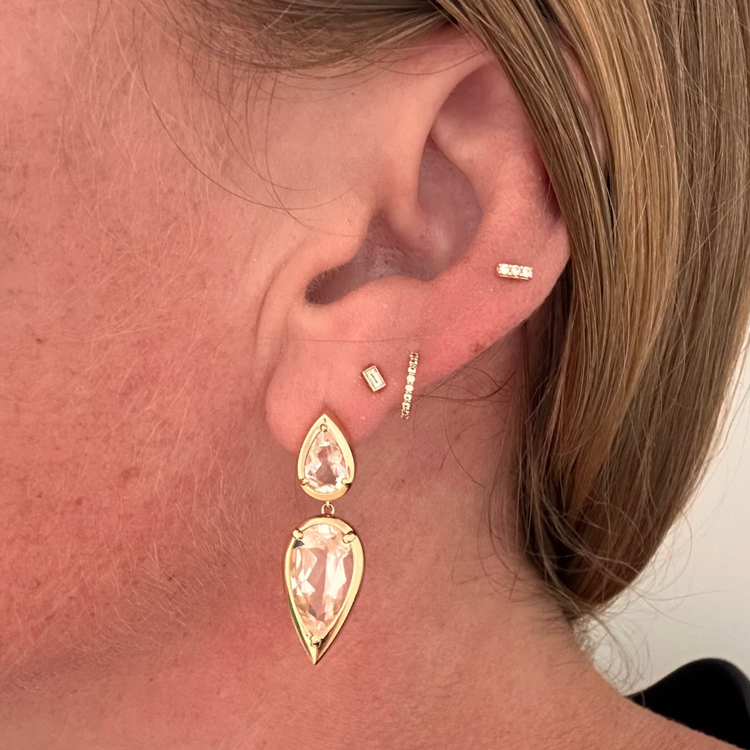 Gold and white topaz teardrop earrings in 14k yellow gold by Elyzian Fine Jewelry