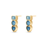 Angled view of a Pair of 14k yellow gold stud earrings featuring bezel-set London Blue, Swiss Blue, and Aquamarine gemstones in geometric shapes.