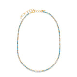 Ombre aquamarine tennis necklace in 14K yellow gold, shown with pale and deeper blue stones and an extension chain.