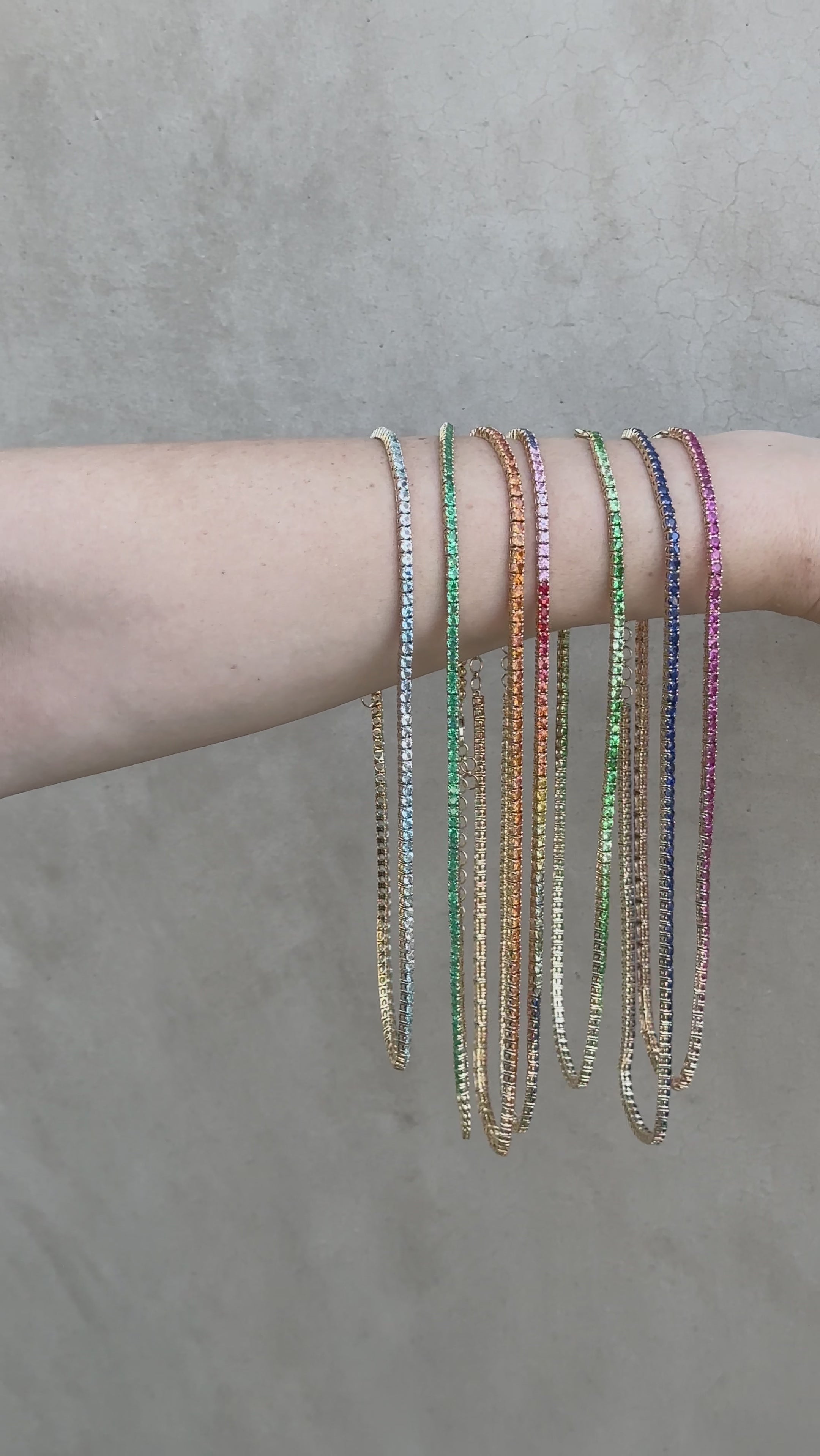 Multiple gemstone tennis necklace in movement. Adjustable ombre tsavorite garnet tennis necklace featuring 22.37ct of vibrant green gemstones, elegantly set in yellow gold with a length range of 40cm to 46cm for a customizable fit.


