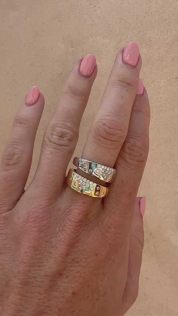 Dual-tone cigar band on a white background; both yellow and white gold have scattered natural diamonds.