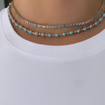 Striking 14K yellow gold necklace featuring 30.5ct of smooth cabochon turquoise and 4.45ct of round brilliant diamonds, with a total weight of 19.89g—a bold and vibrant statement piece.