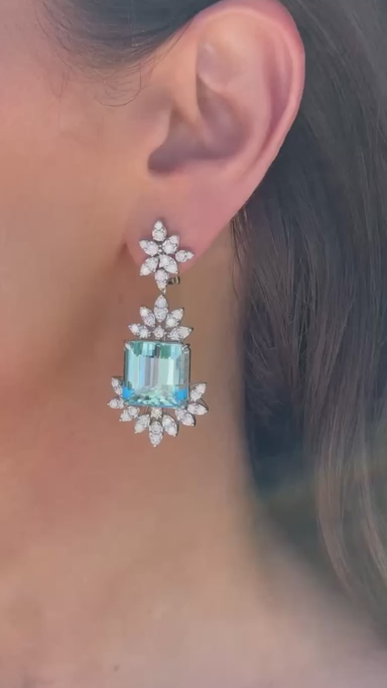 Video of Elyzian emerald-cut aquamarine and diamond drop earrings in 18K white gold.