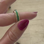 Sleek 14K yellow gold spinning fidget ring featuring vibrant emeralds and radiant diamonds, blending functional stress relief with timeless elegance and sophistication. Mov. 