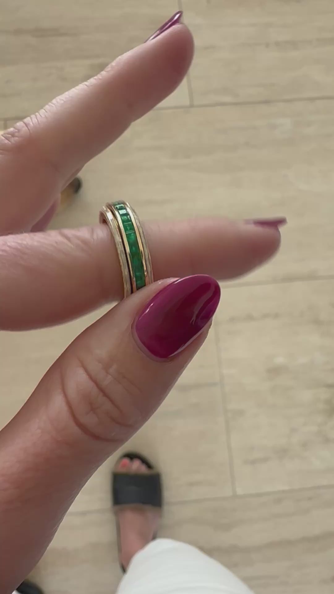 Sleek 14K yellow gold spinning fidget ring featuring vibrant emeralds and radiant diamonds, blending functional stress relief with timeless elegance and sophistication. Mov. 