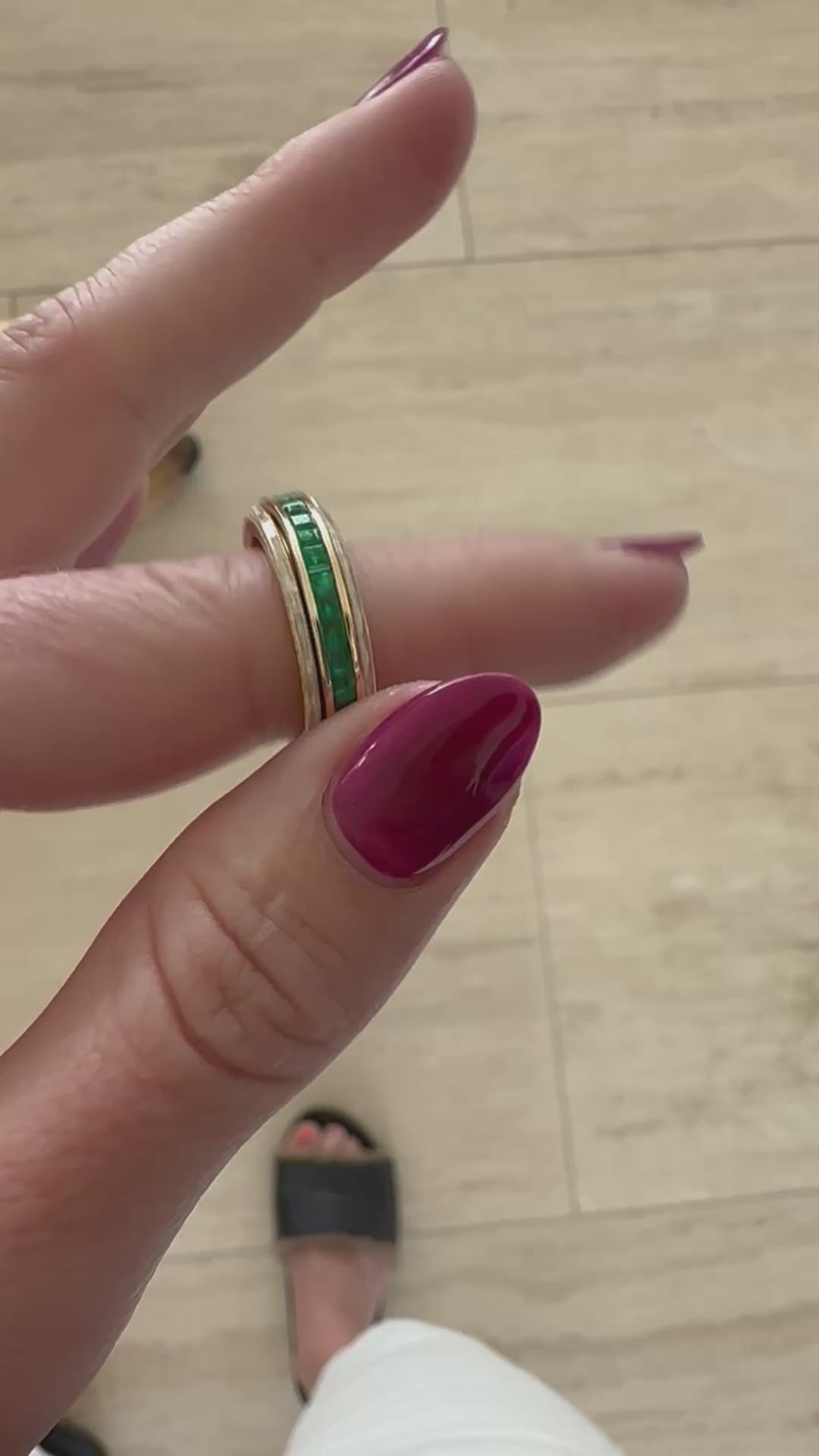Sleek 14K yellow gold spinning fidget ring featuring vibrant emeralds and radiant diamonds, blending functional stress relief with timeless elegance and sophistication. Mov. 