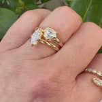 Elegant 14K yellow gold bypass ring featuring 1.2ct of G-H VS diamonds, including pear-shaped ends and graduated solitaires, creating a radiant flurry effect with a graceful silhouette.