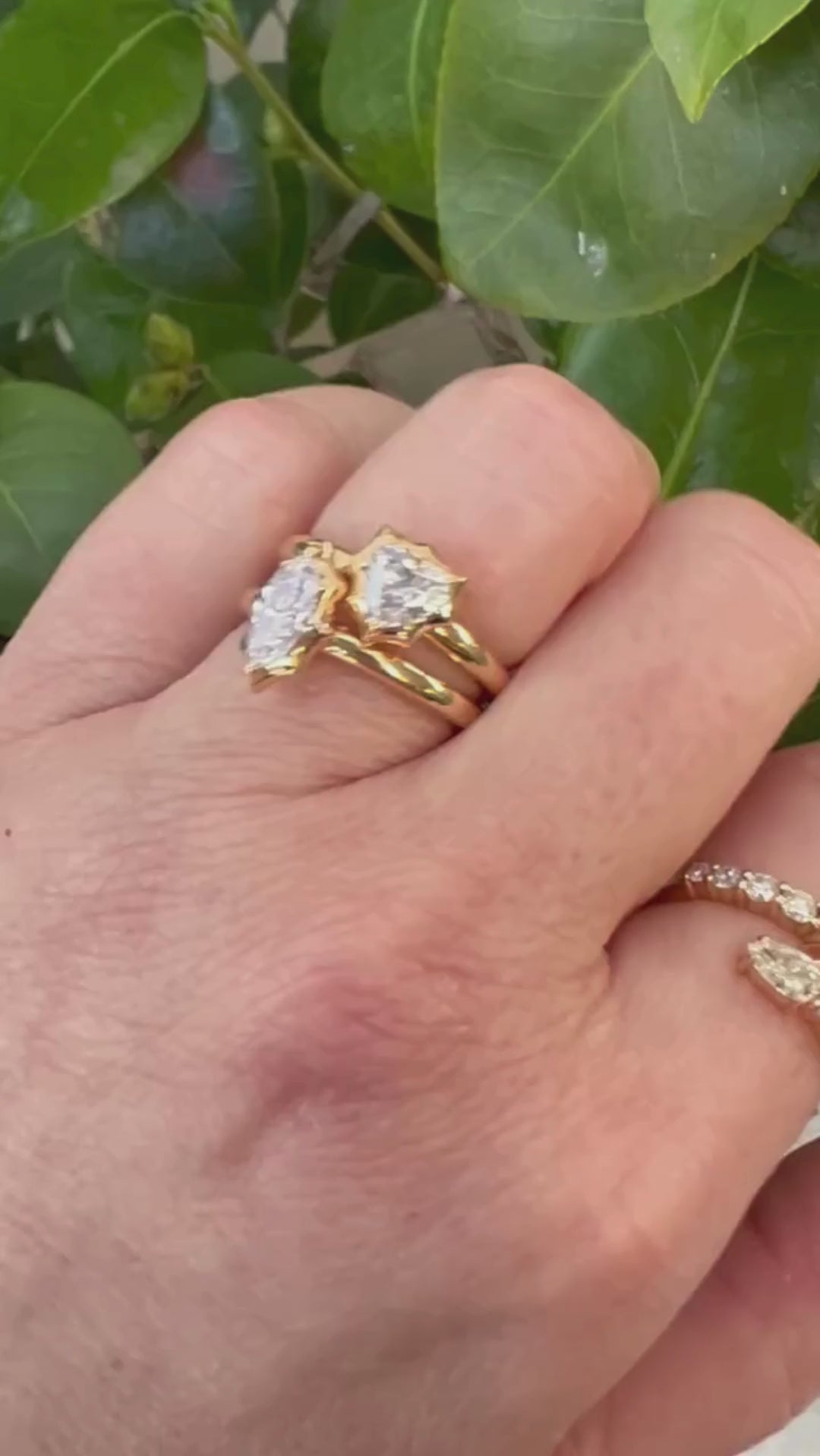 Elegant 14K yellow gold bypass ring featuring 1.2ct of G-H VS diamonds, including pear-shaped ends and graduated solitaires, creating a radiant flurry effect with a graceful silhouette.