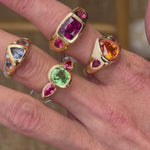 5 elyzian gemstone bezel set trio rings in 18k yellow gold top angle - movie 