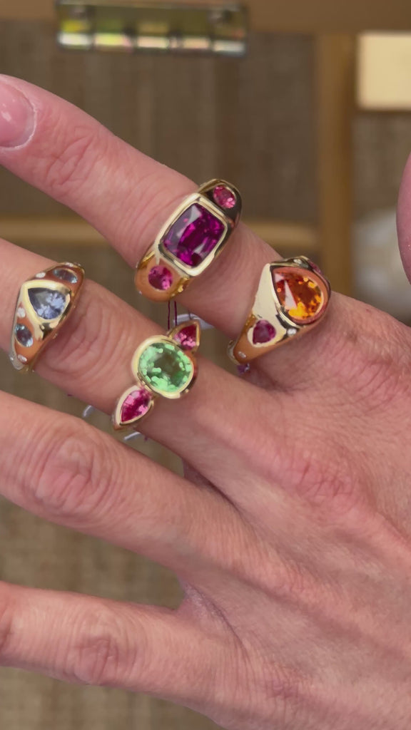 5 elyzian gemstone bezel set trio rings in 18k yellow gold top angle - movie 
