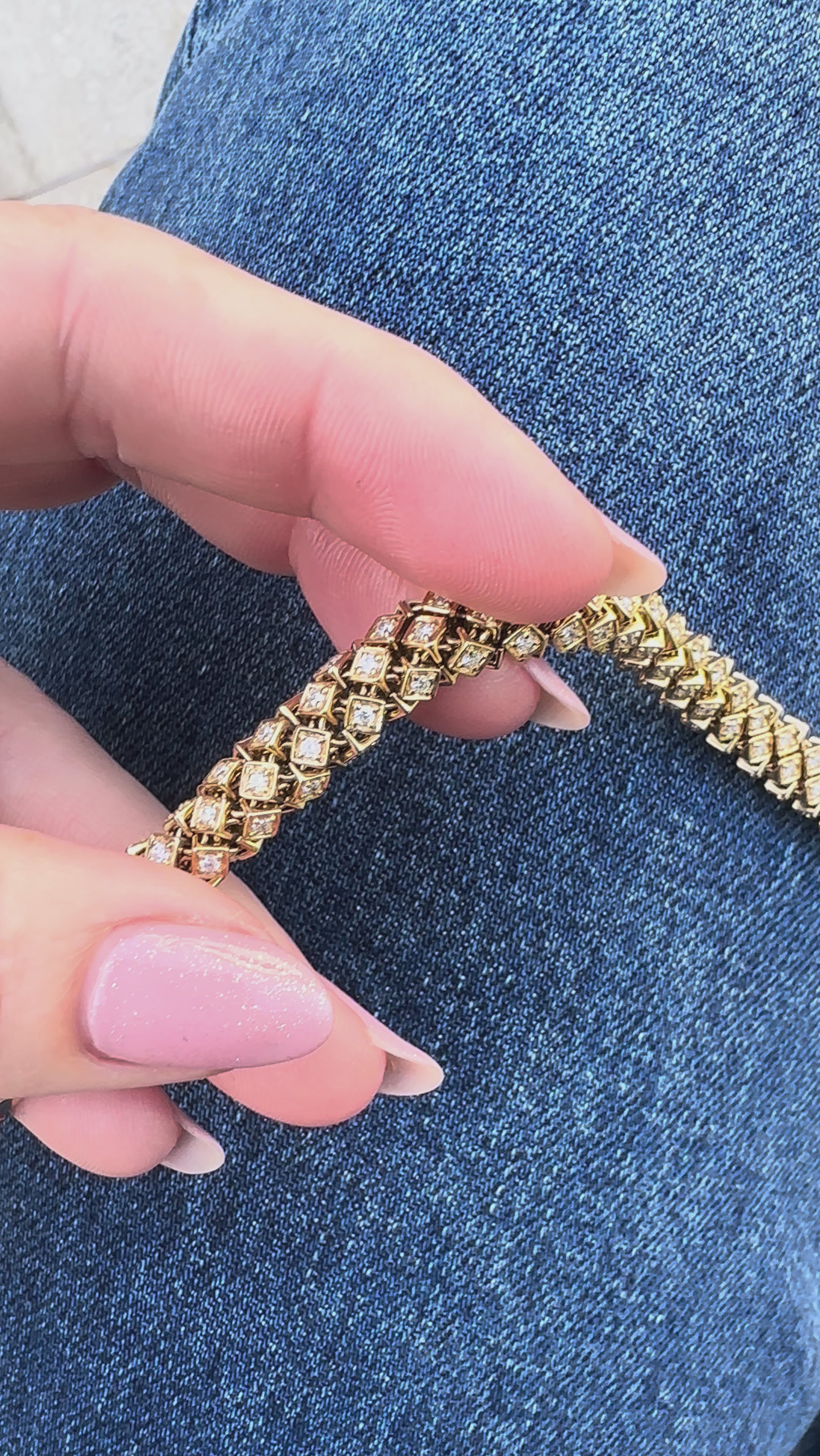 Luxurious 14K yellow gold rope bracelet featuring an intricate woven design accented with dazzling diamonds, blending timeless sophistication with modern brilliance for a stunning statement piece. Close up front view. 