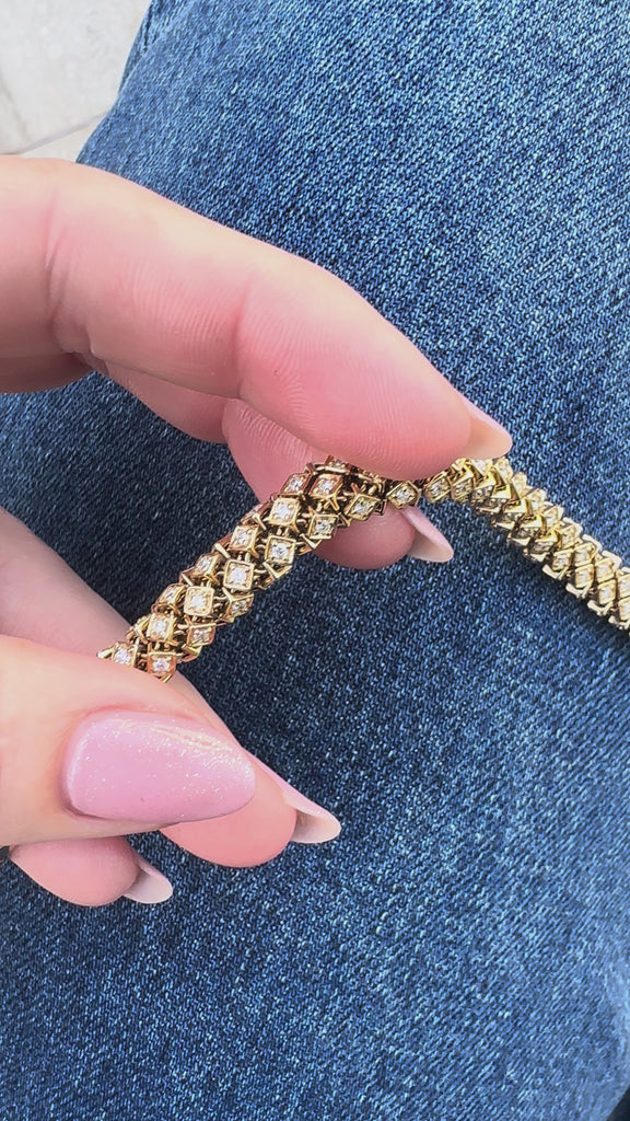 Luxurious 14K yellow gold rope bracelet featuring an intricate woven design accented with dazzling diamonds, blending timeless sophistication with modern brilliance for a stunning statement piece. Close up front view. 