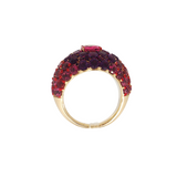 Angled view of A 14k yellow gold dome ring featuring a 1.32ct rubellite center framed by 4.95ct of rhodolite and 2.84ct of amethyst in a pavé setting.