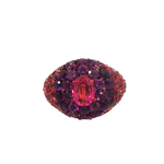 front view of A 14k yellow gold dome ring featuring a 1.32ct rubellite center framed by 4.95ct of rhodolite and 2.84ct of amethyst in a pavé setting.