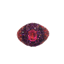 front view of A 14k yellow gold dome ring featuring a 1.32ct rubellite center framed by 4.95ct of rhodolite and 2.84ct of amethyst in a pavé setting.