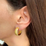 Semi-Flat Round Hoop Earrings in 14K Yellow Gold by Elyzian modeled on ear