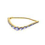 Side view of Tanzanite Wave Bangle in 14K Yellow Gold by Elyzian